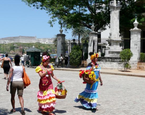 Porteuses de fleurs se faisant photographier pour quelques pièces de monnaie